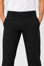 Pantalon de golf homme noir déperlant, vue de face, fermeture à bouton et passants de ceinture.