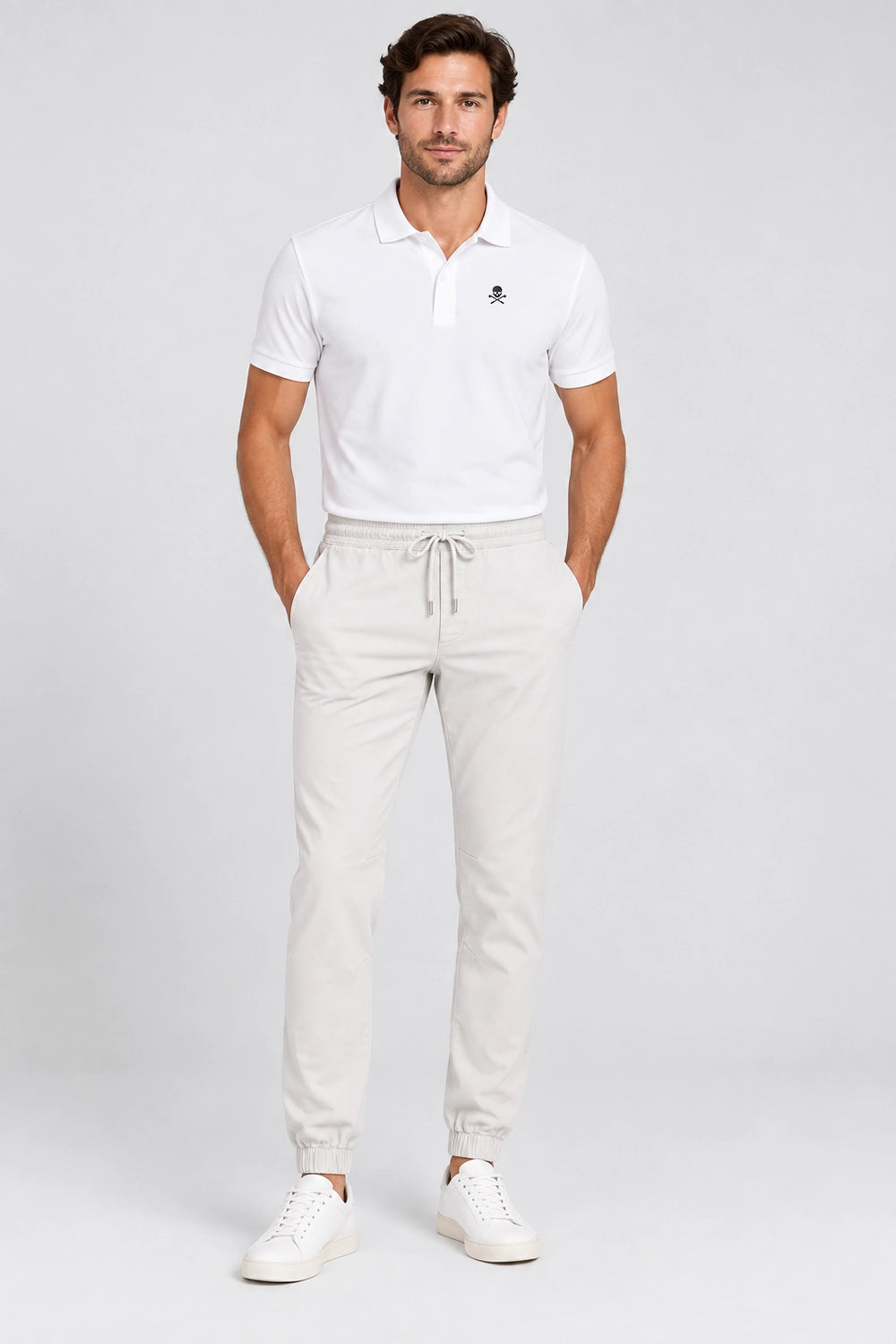 Pantalon de golf homme ivoire, taille élastique, cordon et poches, bas resserré.