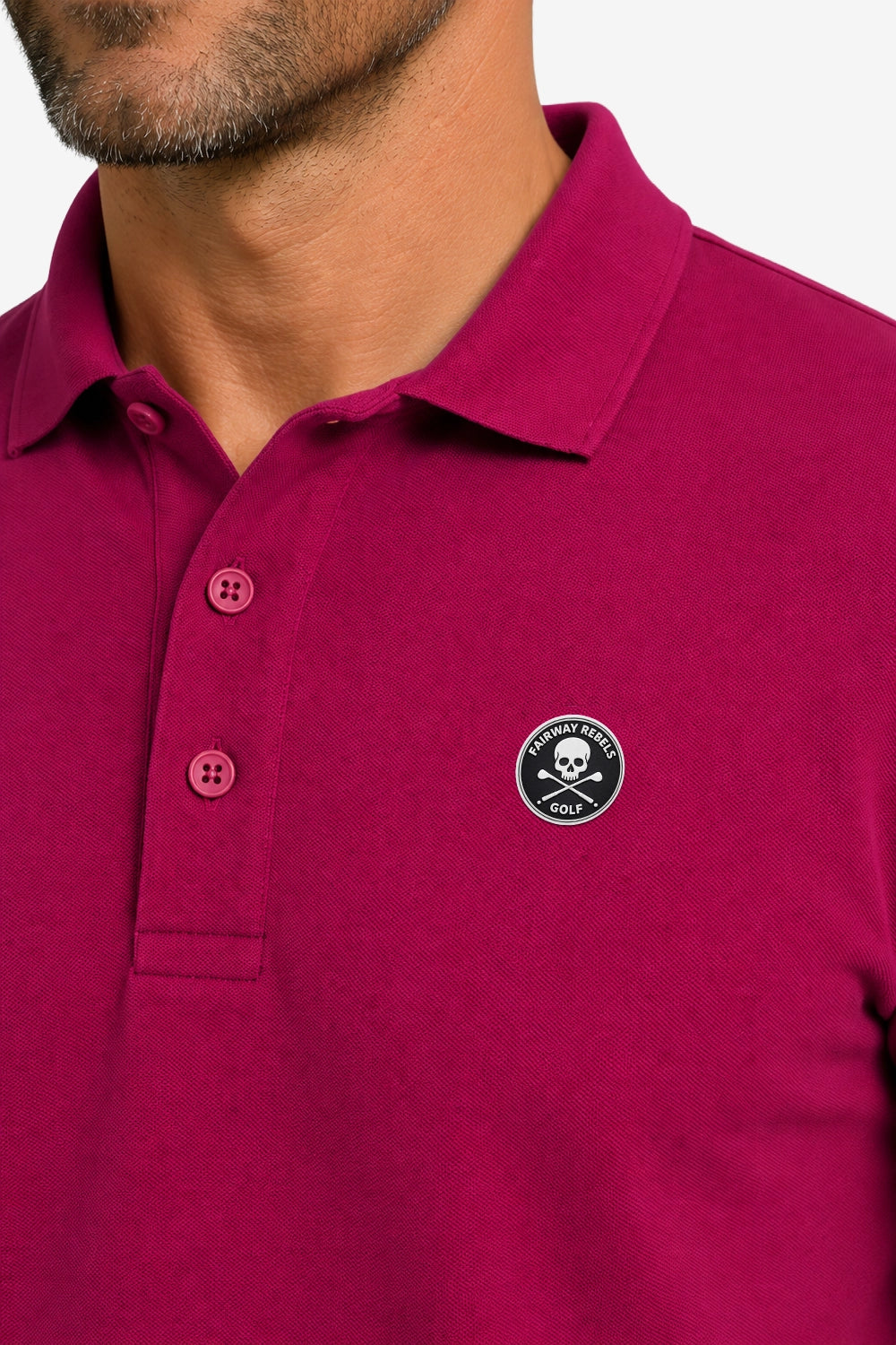 Polo de golf fuchsia manches longues en coton, col boutonné et écusson.