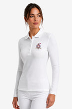 Polo de golf femme manches longues blanc, face 3/4, col boutonné et écusson poitrine.