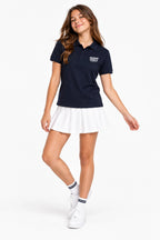 Polo fille en coton bleu marine, col rabattu, petite broderie poitrine.