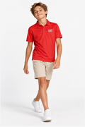 Polo de golf technique enfant rouge, col à 3 boutons, manches courtes, ourlet droit.