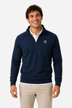 Pull de golf technique homme bleu marine, demi-zip, logo rond poitrine, coupe classique.