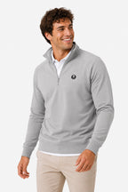Pull de golf technique homme gris clair, demi-zip, logo rond poitrine, manches longues.