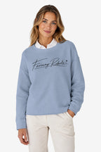 Sweat-shirt de golf pour femme ample bleu ciel, encolure ronde et logo poitrine au trait.