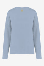 Sweat de golf femme ample bleu ciel, vue dos avec petit emblème jaune.