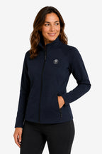 Veste de golf déperlante bleu marine femme, zip noir central et col montant.