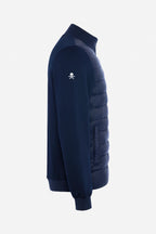 Veste de golf bleu marine, vue de côté, manches tricot, logo sur l’épaule