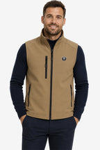 Veste golf sans manches déperlante beige, zip central noir, poches zippées et écusson.