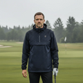 Homme en veste imperméable de golf bleu marine sur un parcours sous la pluie